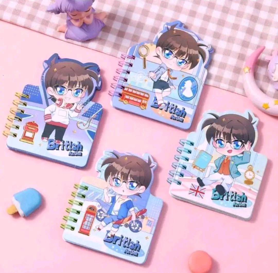 Set of small notebooks with cartoon character design on a pink surface